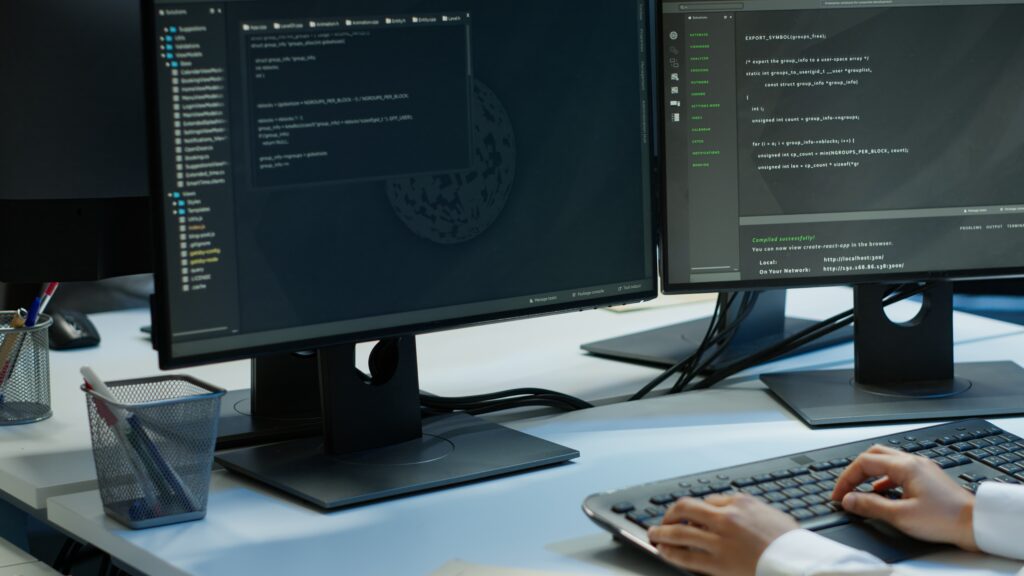 Programmer in data center typing on computer keyboard
